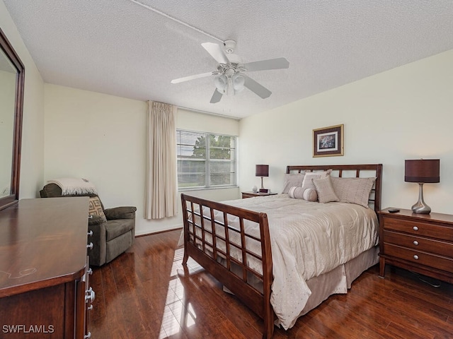 bedroom with a textured ceiling, ceiling fan, and dark hardwood / wood-style flooring