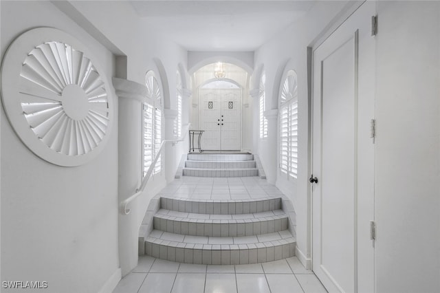 stairway featuring tile patterned floors and a healthy amount of sunlight