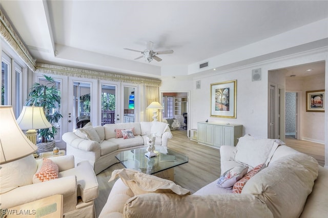 living room with ceiling fan, light wood-type flooring, and french doors