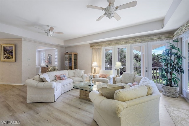 living room with french doors, light hardwood / wood-style floors, and ceiling fan