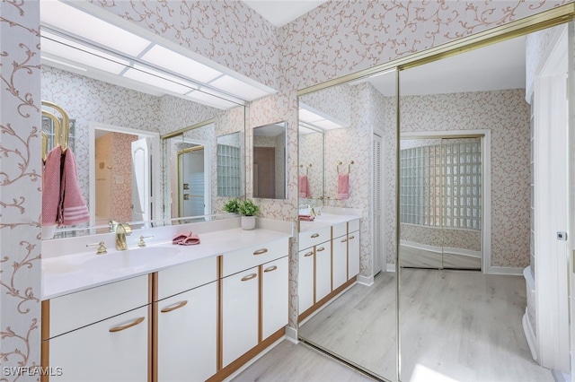 bathroom with hardwood / wood-style floors and vanity