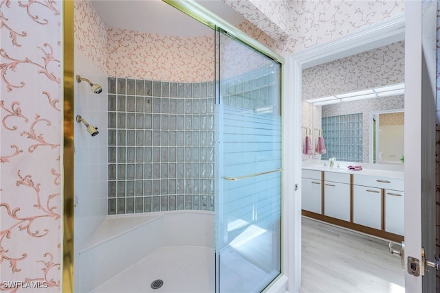 2000 Royal Marco Way Beach Cottage #11, Marco Island, FL 34145 - bathroom featuring wallpapered walls, a shower stall, vanity, and wood finished floors