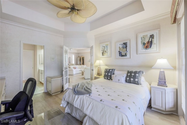 bedroom with light hardwood / wood-style floors, ceiling fan, and ornamental molding