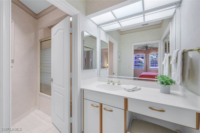 bathroom with tile patterned flooring, shower / bath combination with glass door, vanity, ceiling fan, and crown molding