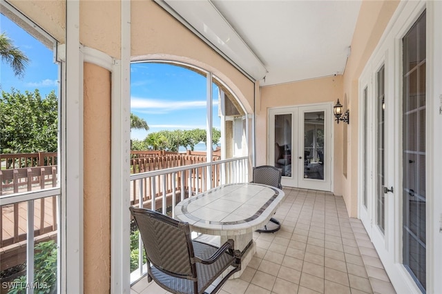 sunroom featuring french doors and a wealth of natural light