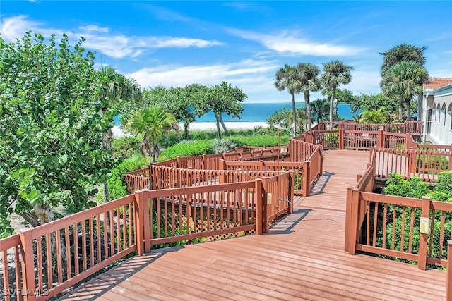 deck with a view of the beach and a water view