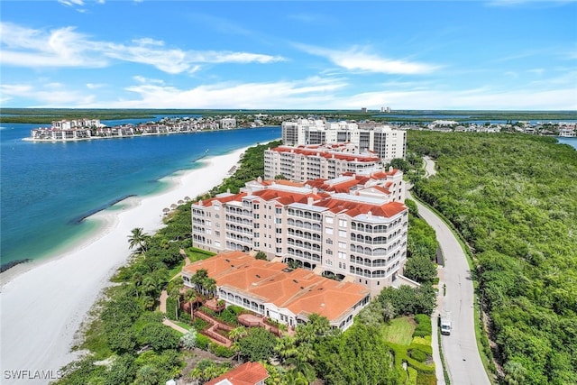 birds eye view of property with a water view and a view of the beach