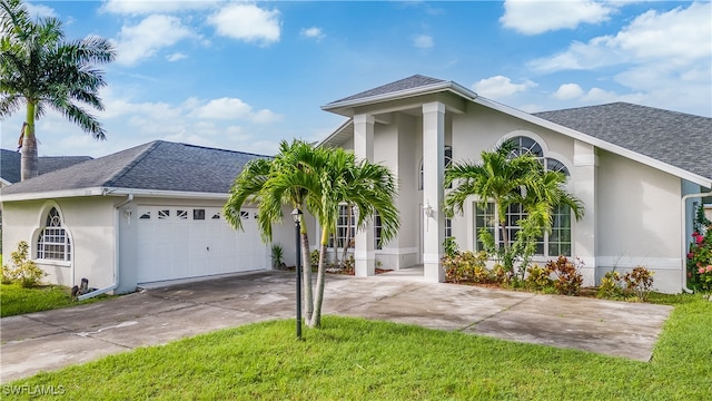 view of front of property with a front yard and a garage