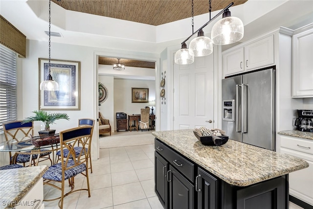 kitchen with a kitchen island, high end refrigerator, hanging light fixtures, and white cabinets