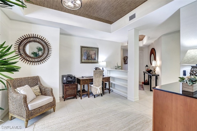 tiled home office featuring a tray ceiling