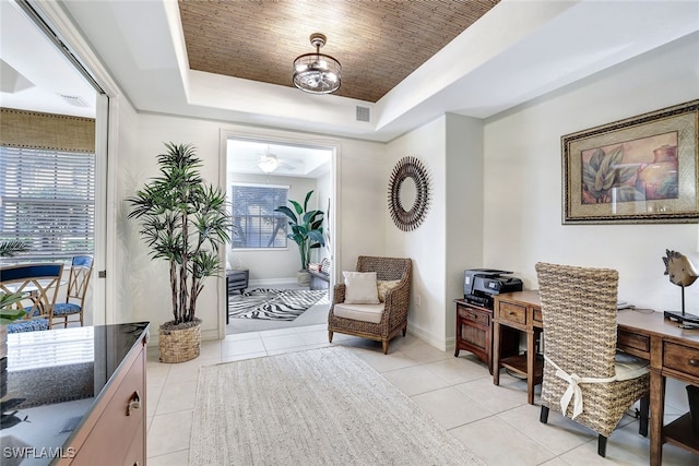 tiled office featuring a tray ceiling