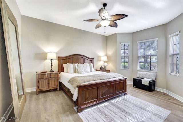 bedroom with light hardwood / wood-style floors and ceiling fan