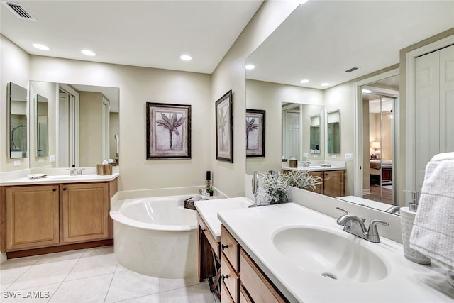 bathroom featuring a bath, vanity, and tile patterned floors