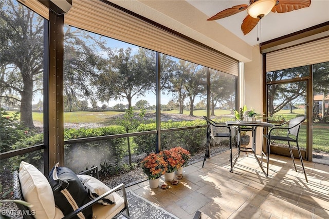 sunroom featuring ceiling fan