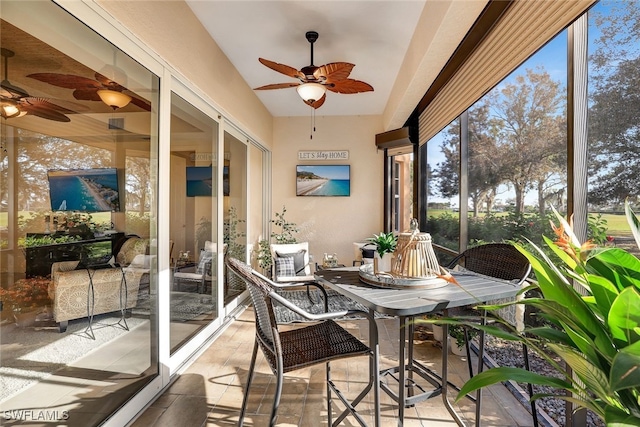 sunroom / solarium featuring ceiling fan