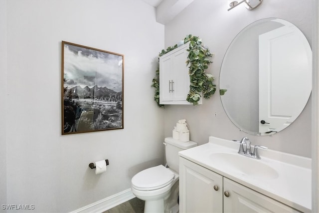 bathroom featuring toilet and vanity