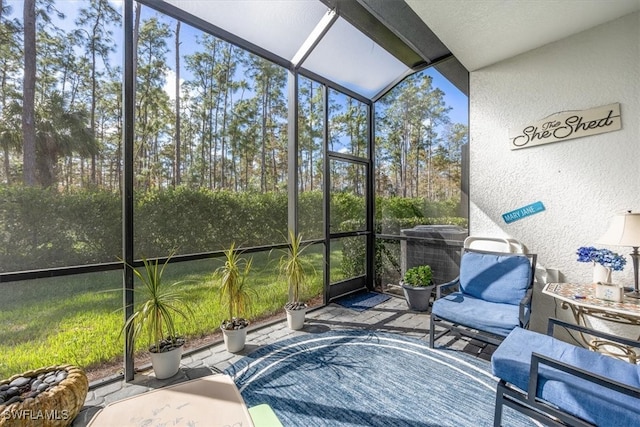 sunroom with a wealth of natural light and lofted ceiling