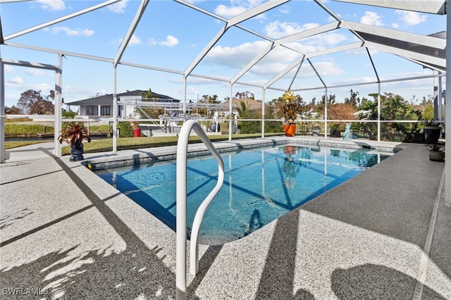 view of swimming pool featuring a lanai and a patio