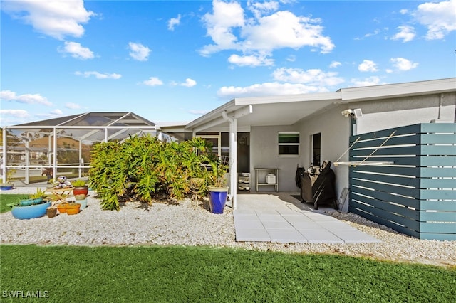 back of property with a patio area and a lanai