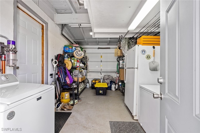 garage with white fridge and washer / clothes dryer