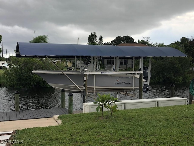 view of dock featuring a water view and a yard