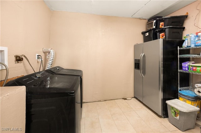 11831 Iona Rd, Fort Myers, FL 33908 - laundry room with washer and dryer and light tile patterned floors