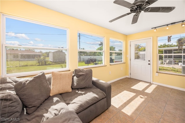 sunroom with ceiling fan and plenty of natural light