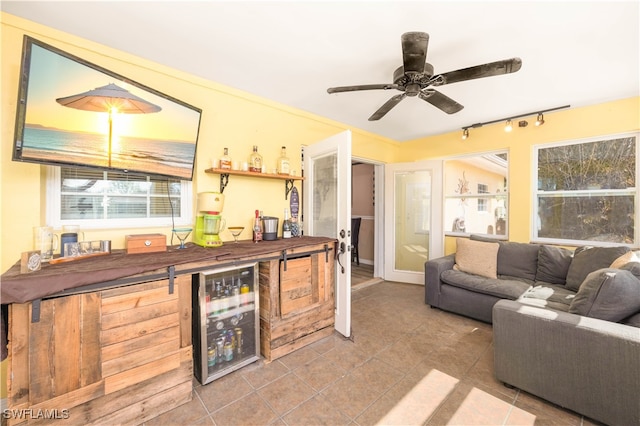 interior space with wood counters, track lighting, tile patterned floors, and ceiling fan