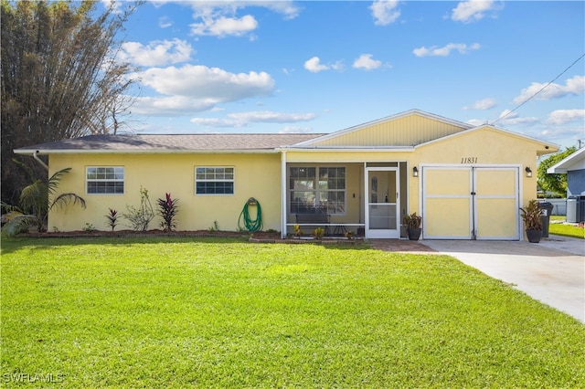 single story home with a garage, a front lawn, and a sunroom