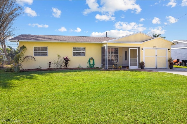 single story home featuring a front yard, a shed, and a sunroom