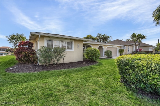 ranch-style home with a front yard and a garage