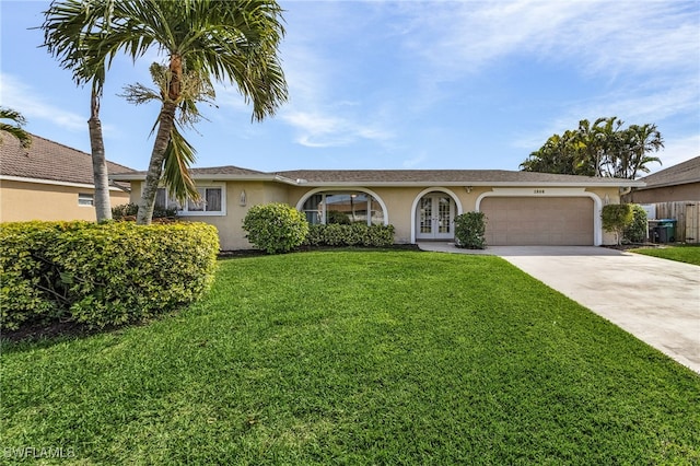 ranch-style house with a front yard, french doors, and a garage