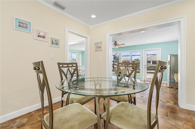 dining space featuring crown molding and ceiling fan