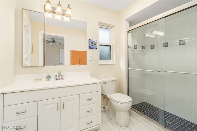 bathroom featuring vanity, tile patterned floors, toilet, and an enclosed shower