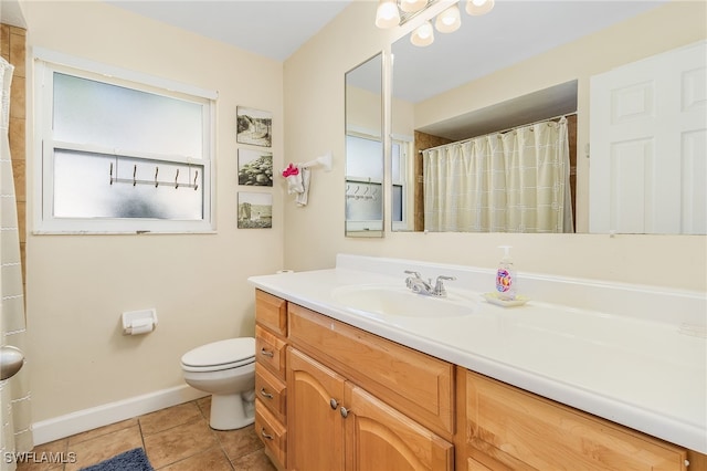 bathroom with vanity, toilet, and tile patterned flooring