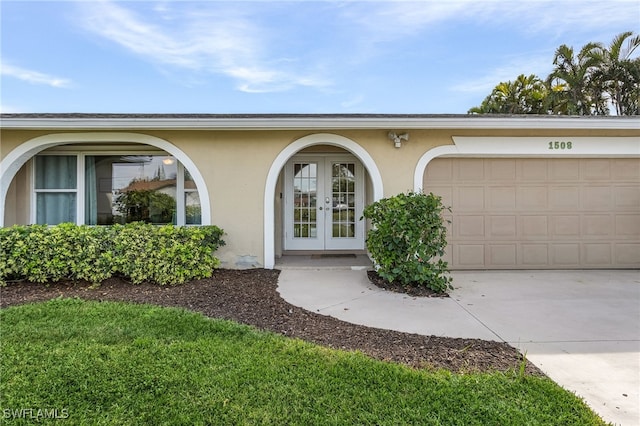 doorway to property featuring french doors and a garage