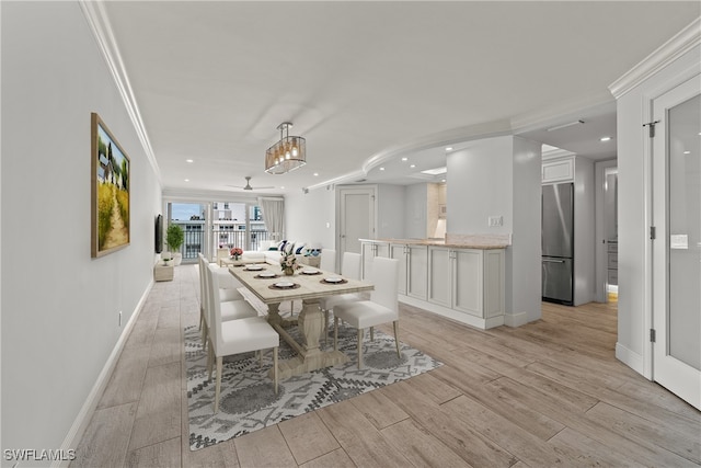 dining room with light hardwood / wood-style floors, ceiling fan, and crown molding