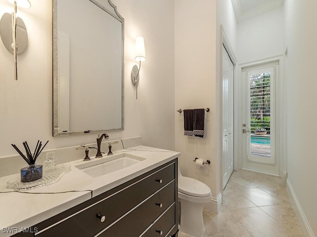 bathroom featuring tile patterned floors, vanity, and toilet