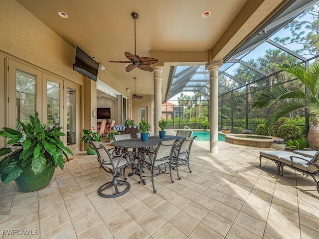 view of patio / terrace featuring a swimming pool with hot tub, a lanai, and ceiling fan