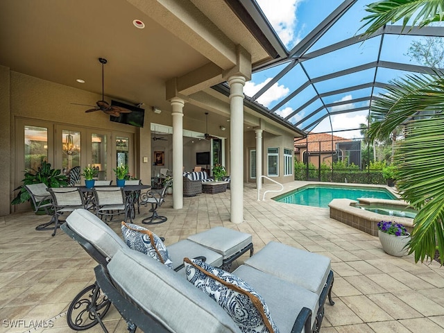 view of pool with a lanai, ceiling fan, a patio, an outdoor hangout area, and an in ground hot tub