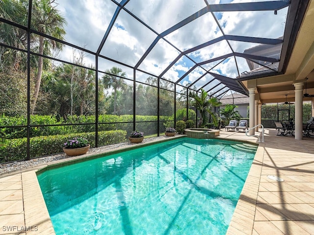 view of pool featuring a lanai, a patio, and an in ground hot tub