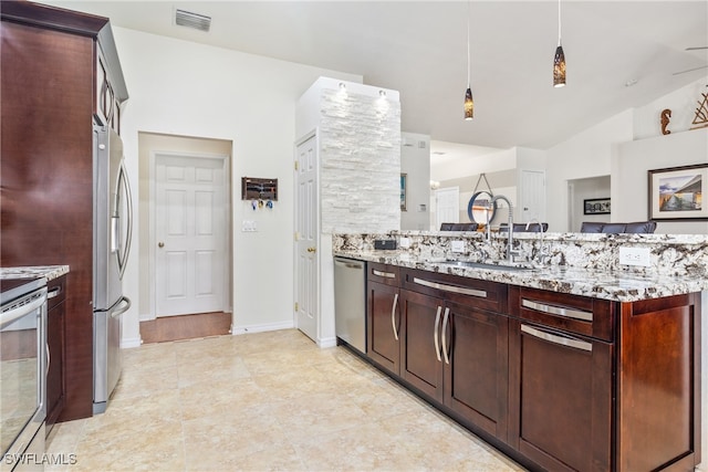 kitchen featuring stainless steel appliances, lofted ceiling, sink, and light stone counters