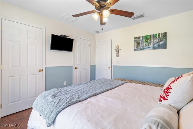 bedroom with dark wood-type flooring and ceiling fan