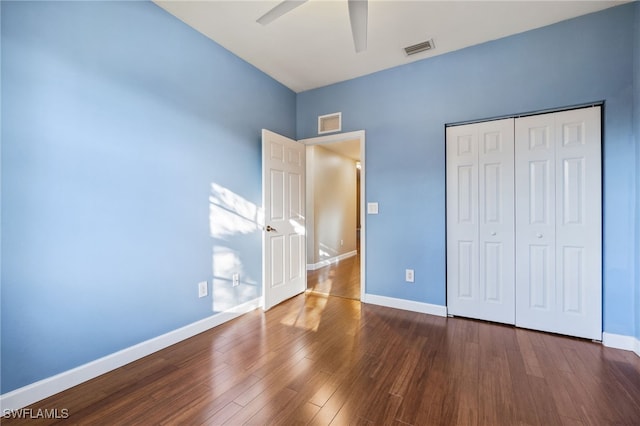 unfurnished bedroom featuring a closet, ceiling fan, and dark hardwood / wood-style floors