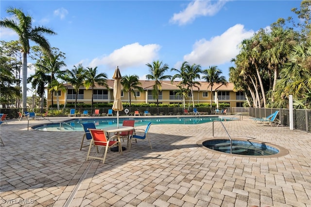 view of pool with a patio and a hot tub