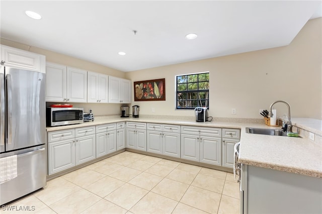 kitchen with sink, white cabinets, and stainless steel appliances