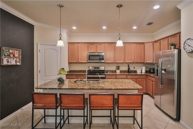 kitchen featuring light tile patterned floors, an island with sink, ornamental molding, sink, and stainless steel appliances