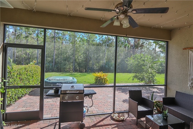 sunroom featuring ceiling fan