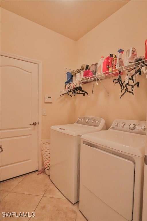 washroom featuring light tile patterned flooring and washer and clothes dryer