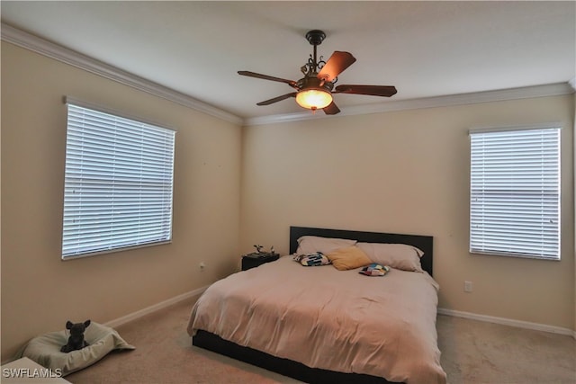 carpeted bedroom with crown molding and ceiling fan